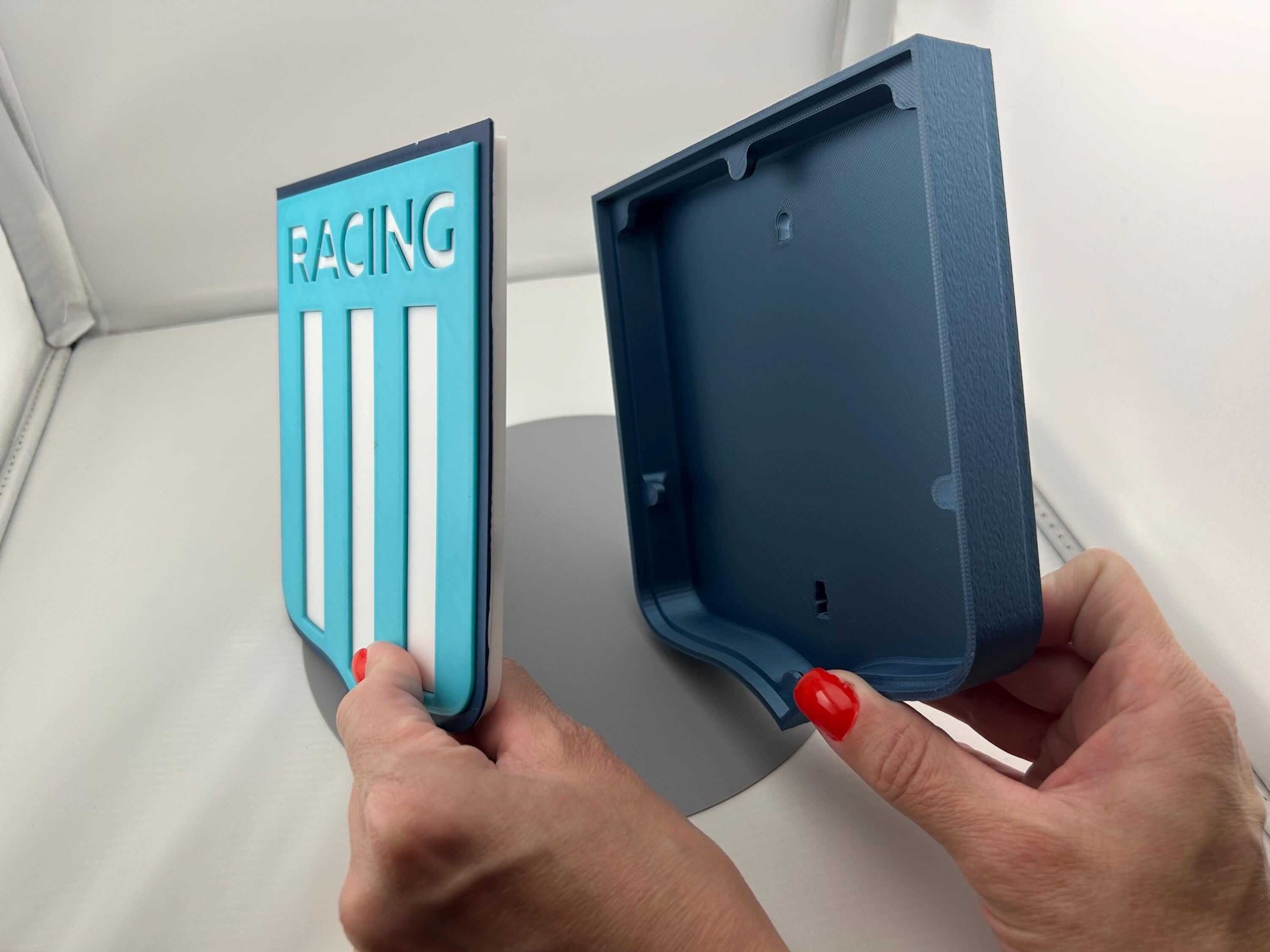 Hands holding a Racing Club de Avellaneda fan gift, showcasing vibrant colors and unique 3D design, no assembly required.