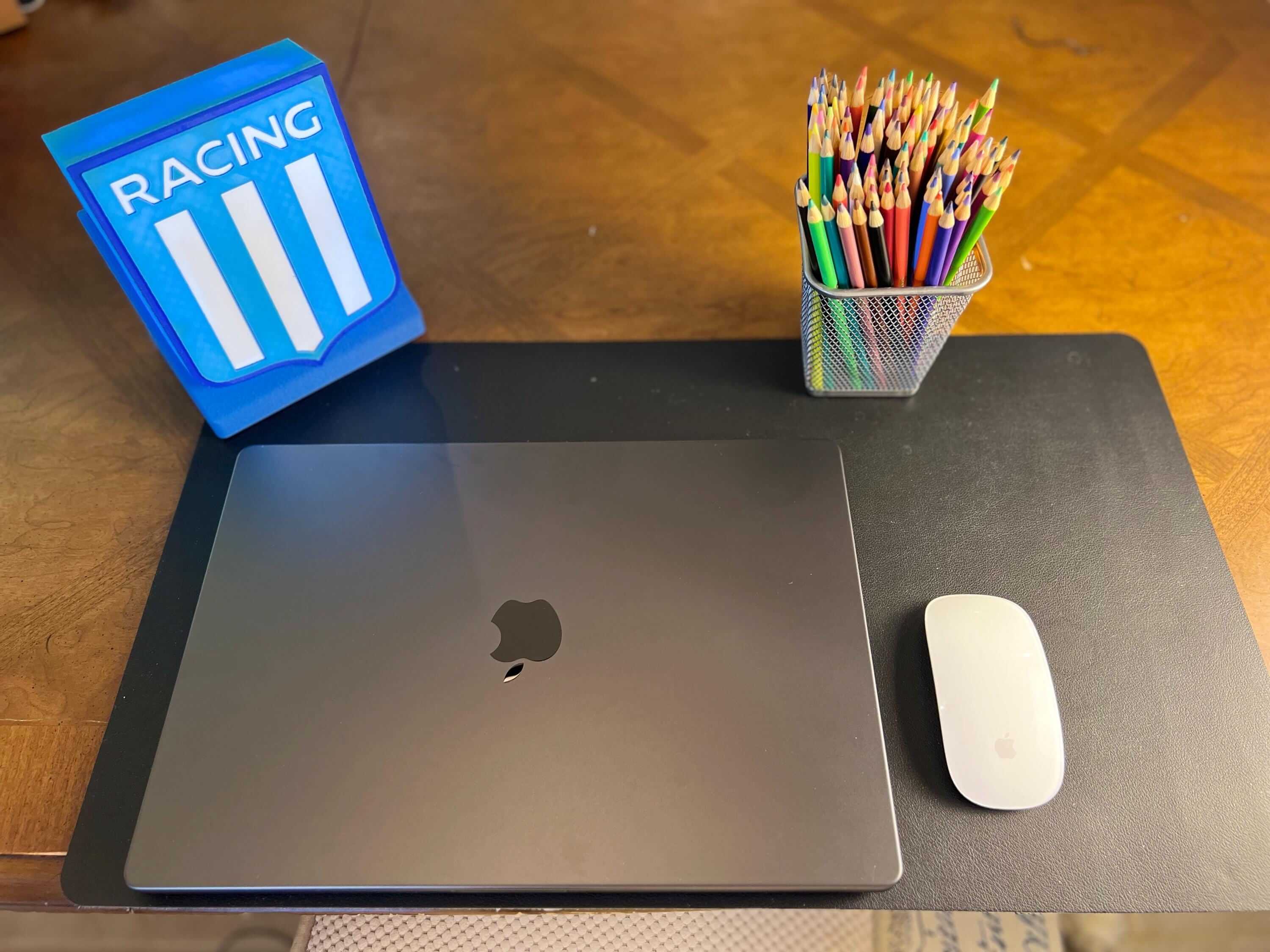 Racing Club de Avellaneda fan gift on desk with laptop and colorful pencils, perfect for soccer enthusiasts.