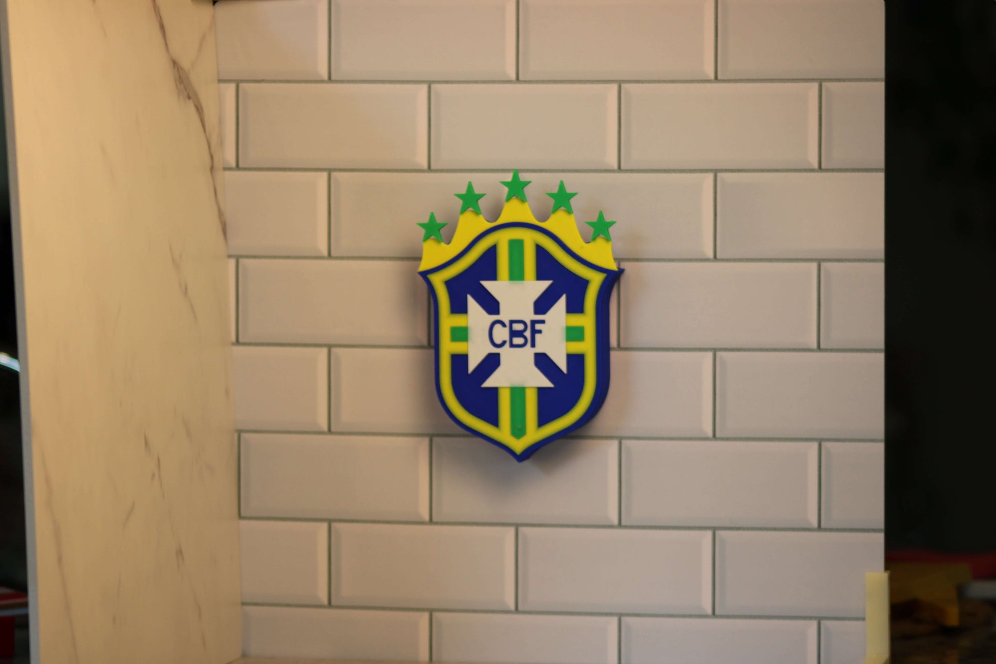Brazil National Team 3D printed emblem on tiled wall, showcasing vibrant colors and unique design for soccer fans.