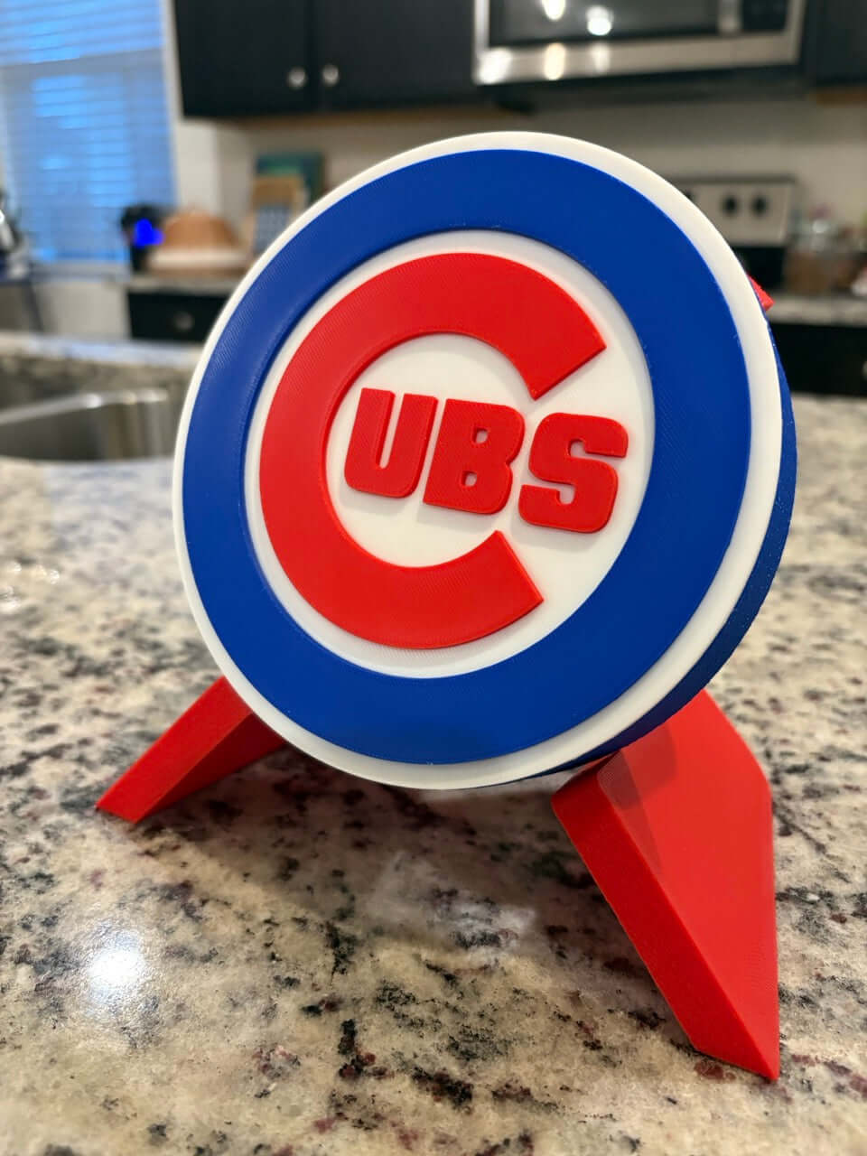3D printed Chicago Cubs plaque on a countertop, featuring vibrant colors and unique design, perfect for baseball fans.