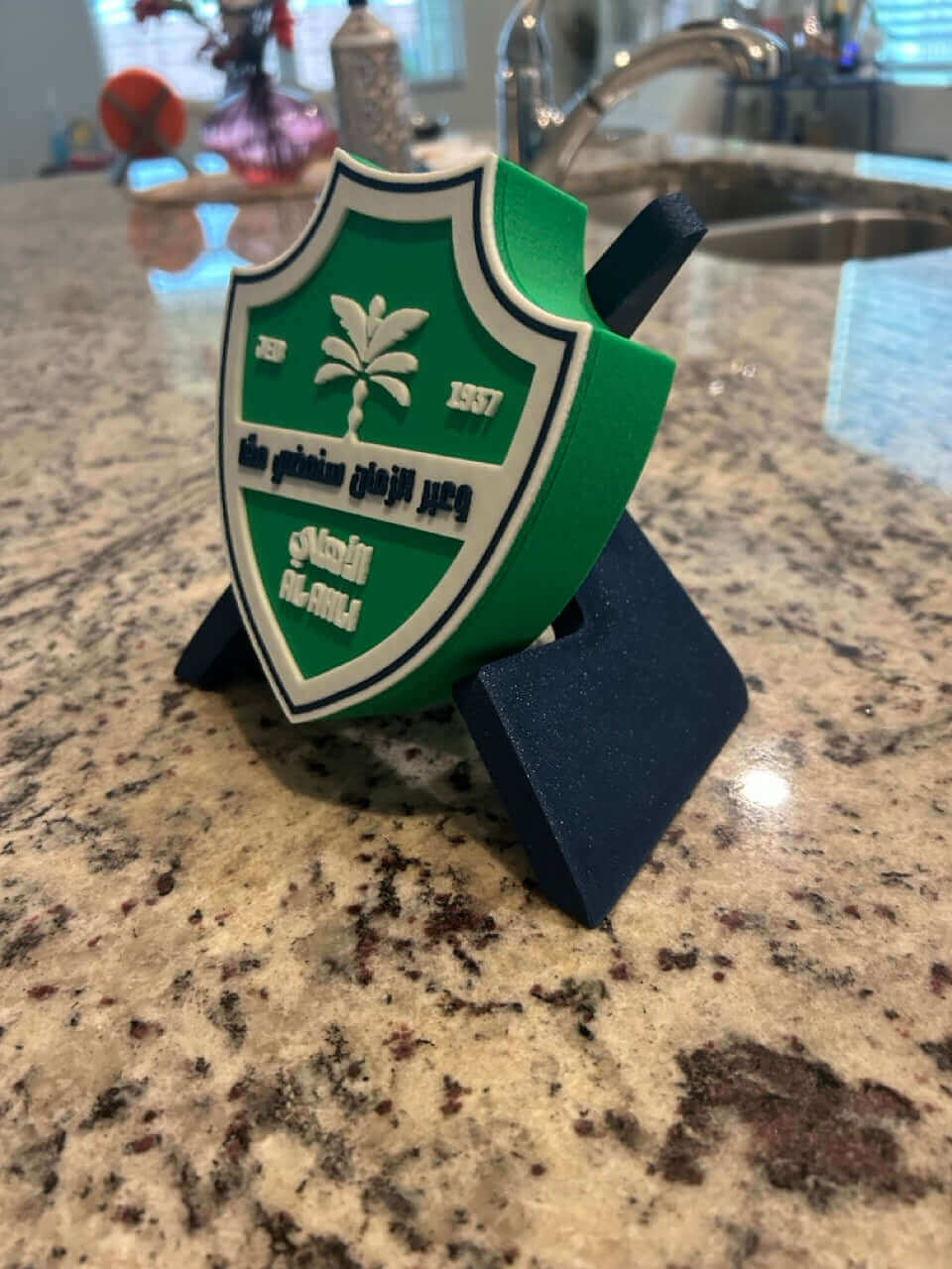 Al-Ahli FC 3D printed crest plaque in green and white, displayed on a stand, eco-friendly decor for soccer fans.
