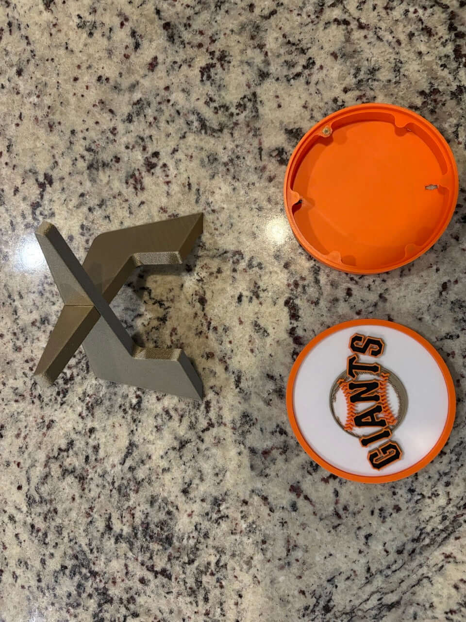 Customized San Francisco Giants 3D printed plaque components on a granite countertop, showcasing vibrant colors and unique design.