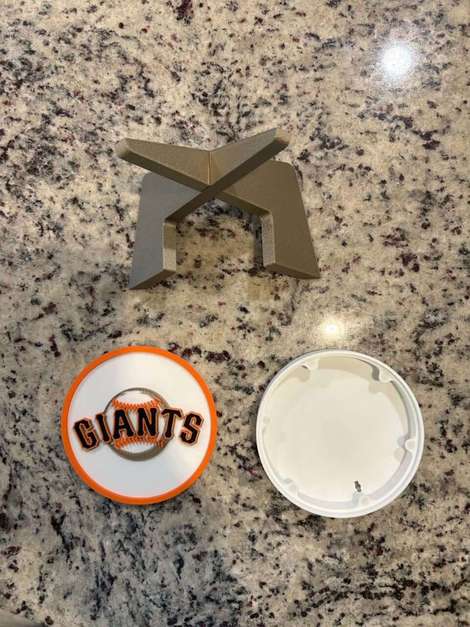 Customized San Francisco Giants 3D printed plaque pieces on a granite surface, showcasing unique MLB sports decor.