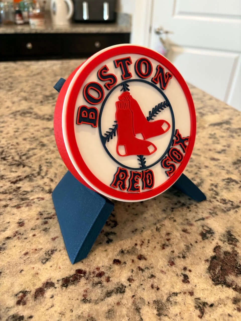 Customized Boston Red Sox 3D printed plaque on a countertop, showcasing vibrant colors and unique design for sports decor.