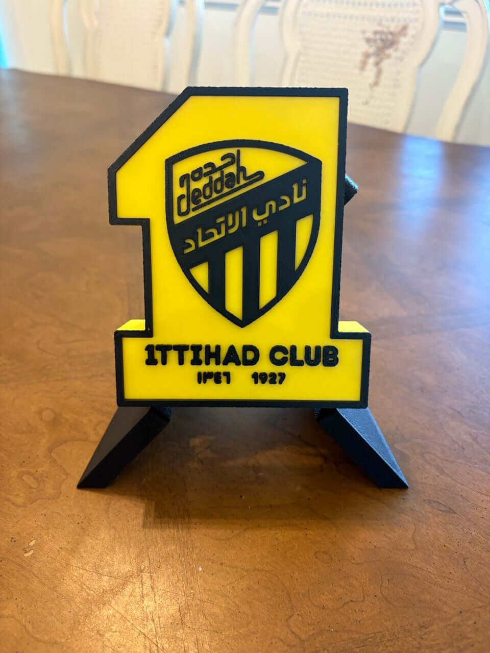 Al-Ittihad Club 3D printed plaque in vibrant yellow and black, perfect for soccer fans and unique decor.