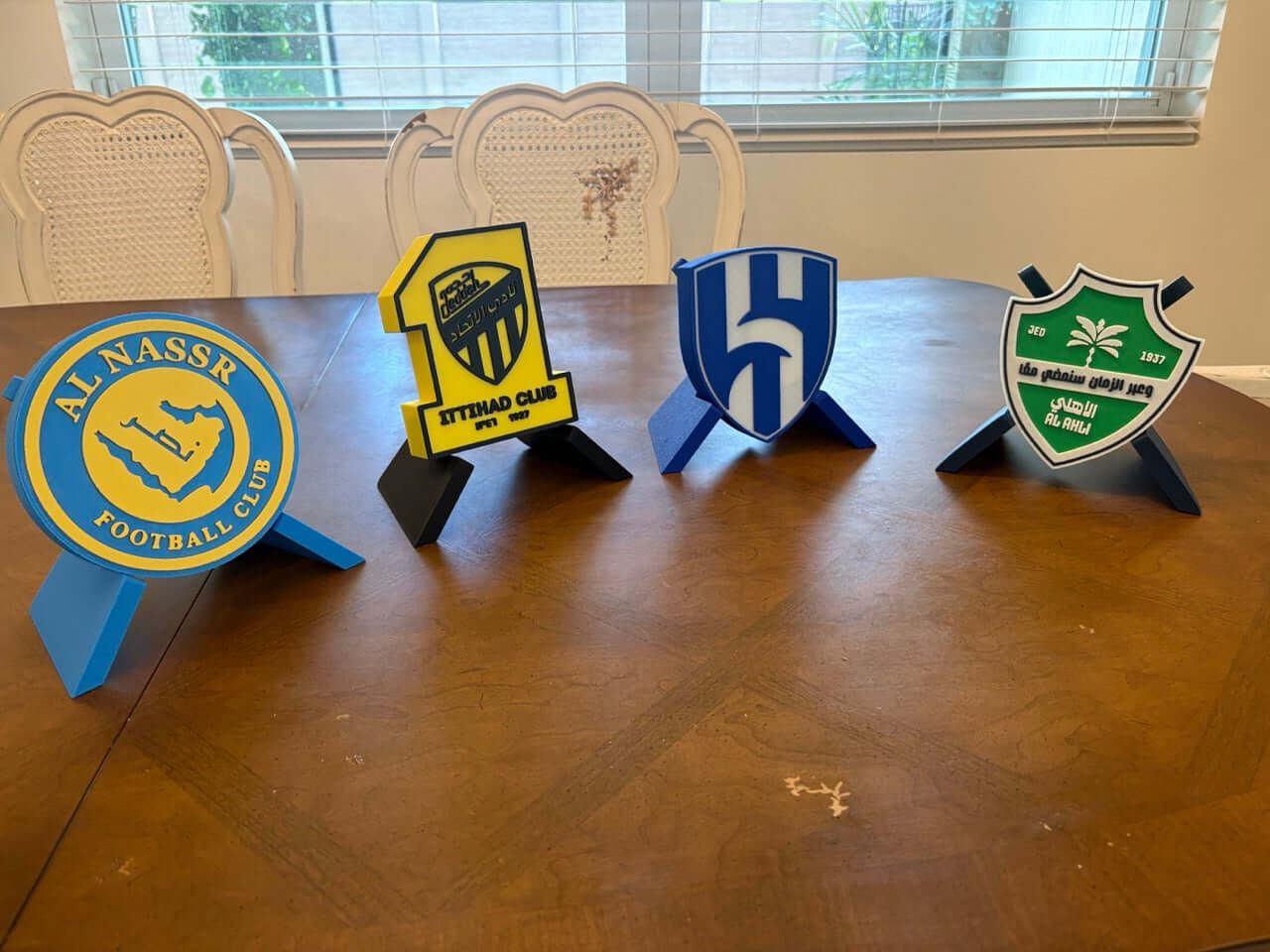 Colorful 3D printed plaques of Al-Nassr, Al-Ittihad, Al-Hilal, and Al-Ahli clubs, perfect for Saudi League fans.