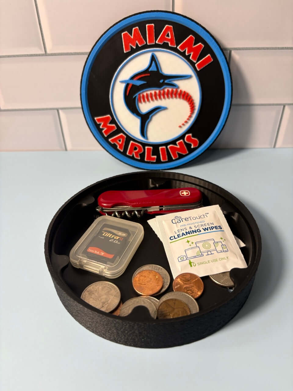 Miami Marlins 3D logo stash box with assorted coins and tools, a unique customizable fan gift in vibrant colors.