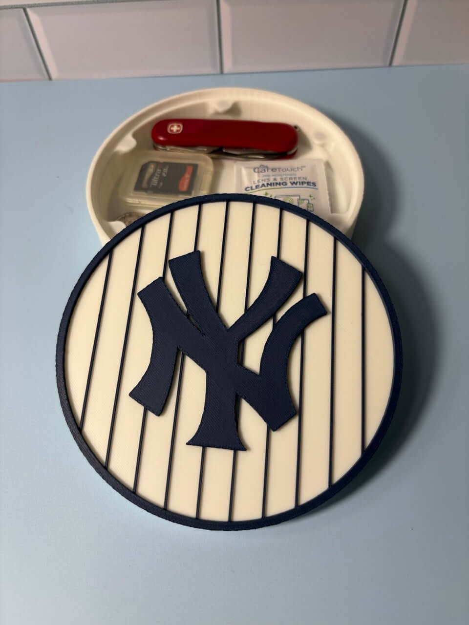 NY Yankees 3D logo stash box with red pocket knife, unique fan gift, vibrant colors, no assembly required.