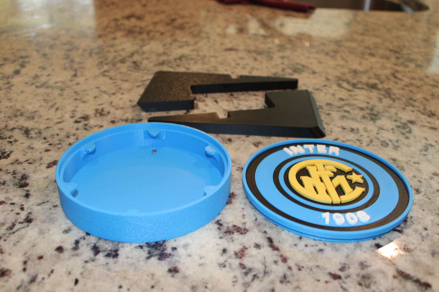 Inter Milan Retro 3D Printed Emblem pieces on a counter, featuring vibrant colors and unique design for soccer fans.