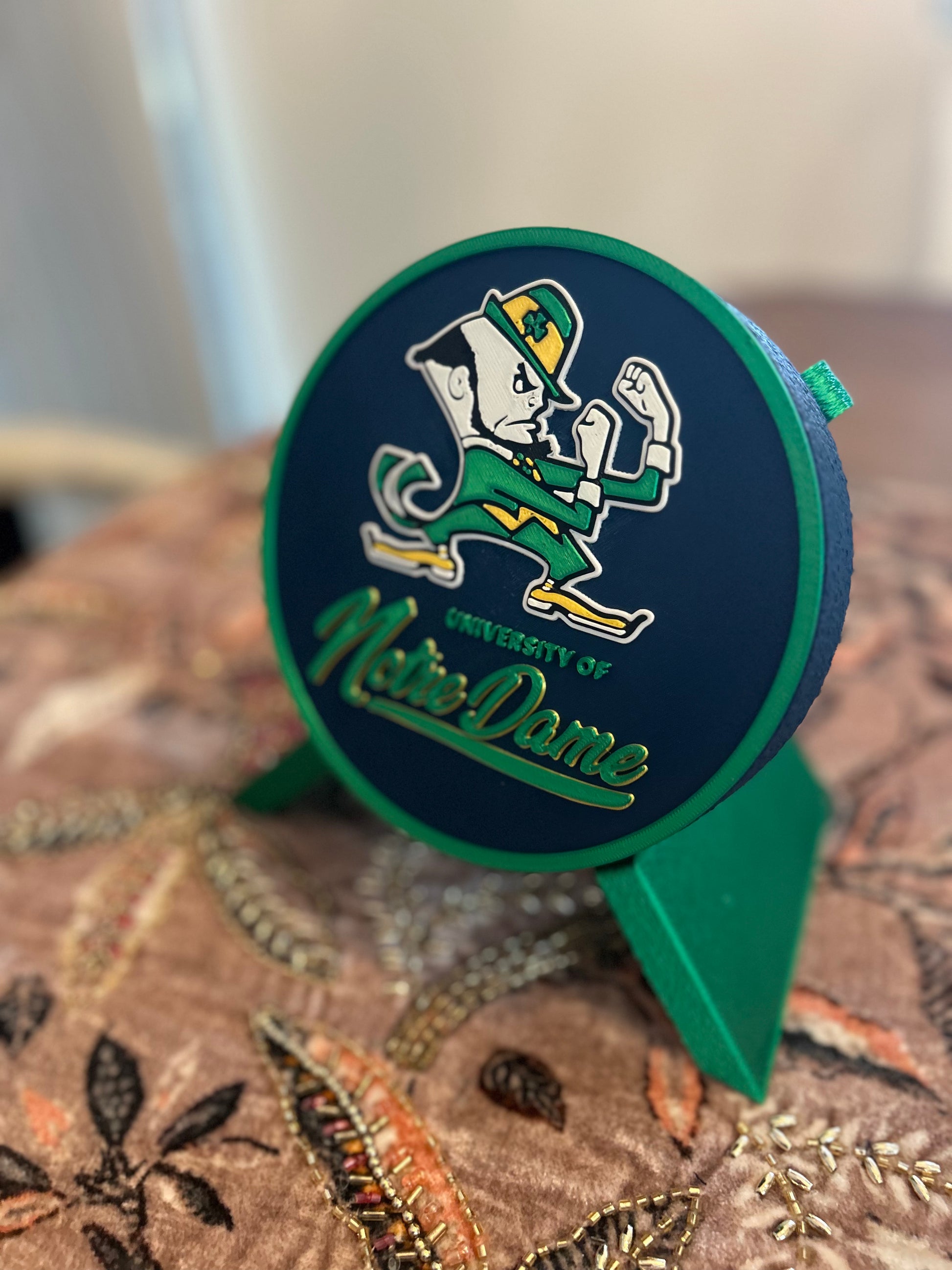 Notre Dame Fighting Irish leprechaun 3D printed round storage box with blue base and wedge display stand