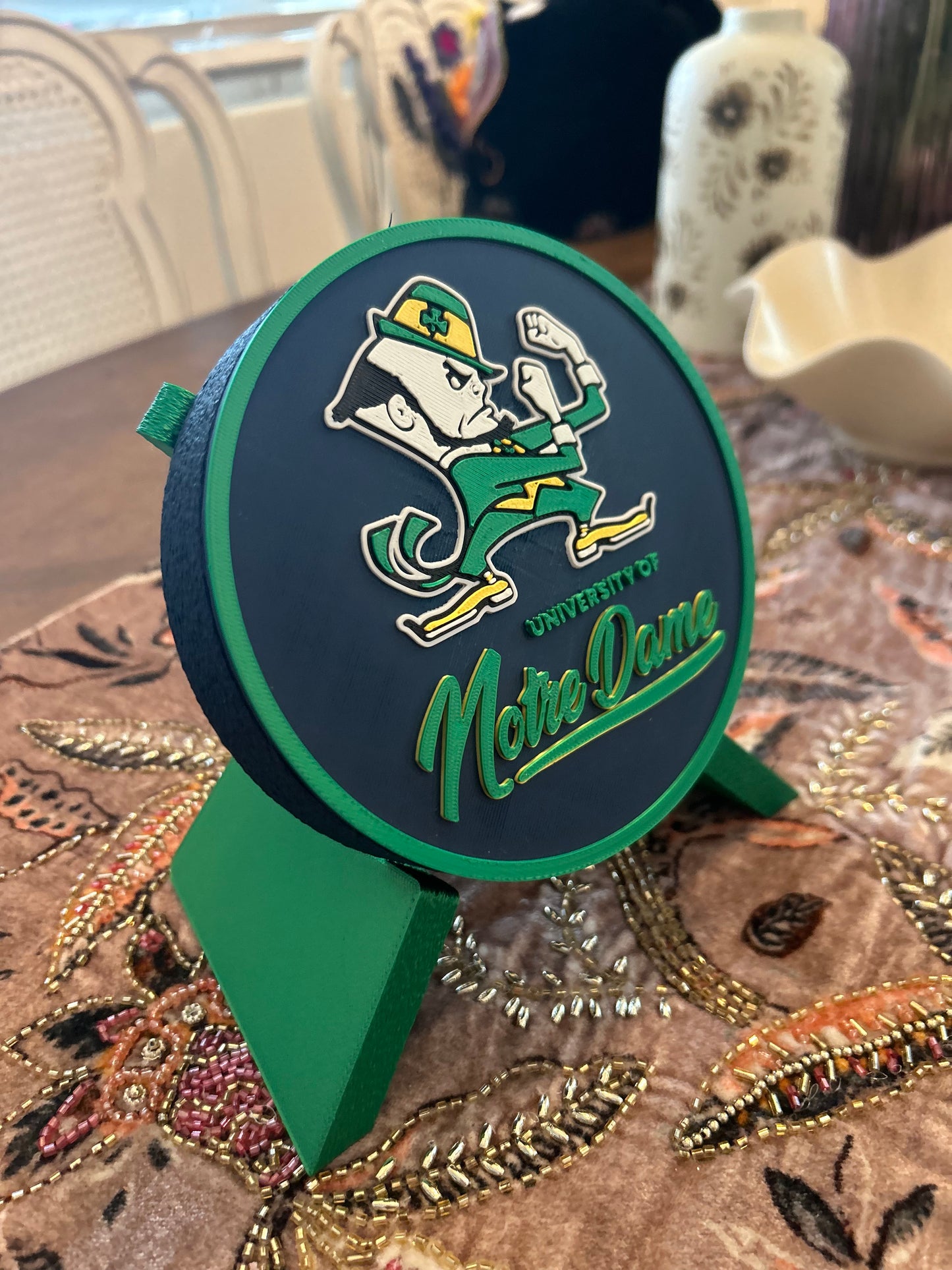 Notre Dame Fighting Irish leprechaun 3D printed round storage box with blue base and wedge display stand