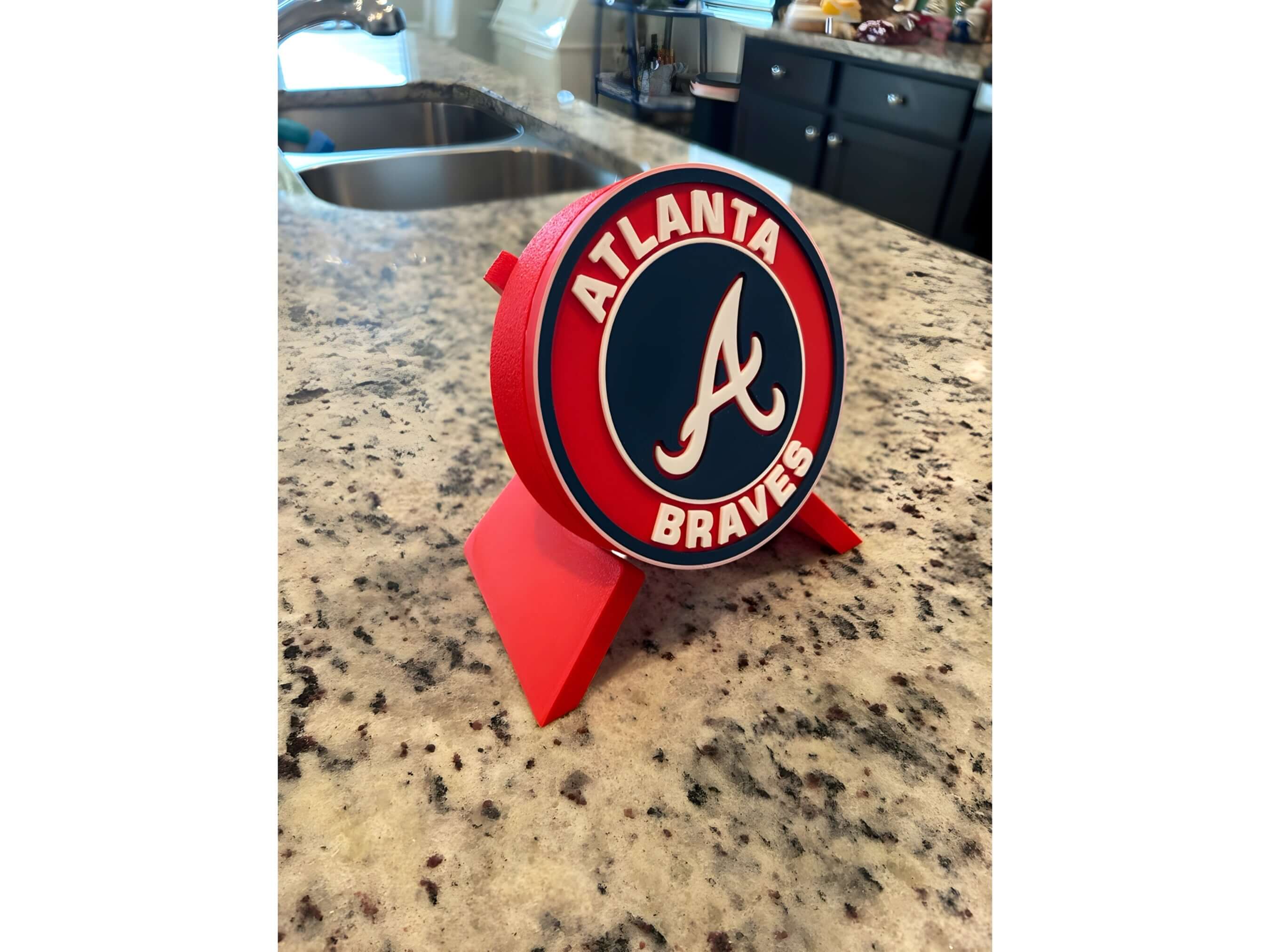 Atlanta Braves 3D printed plaque on kitchen counter, vibrant team colors, perfect decor for baseball fans.