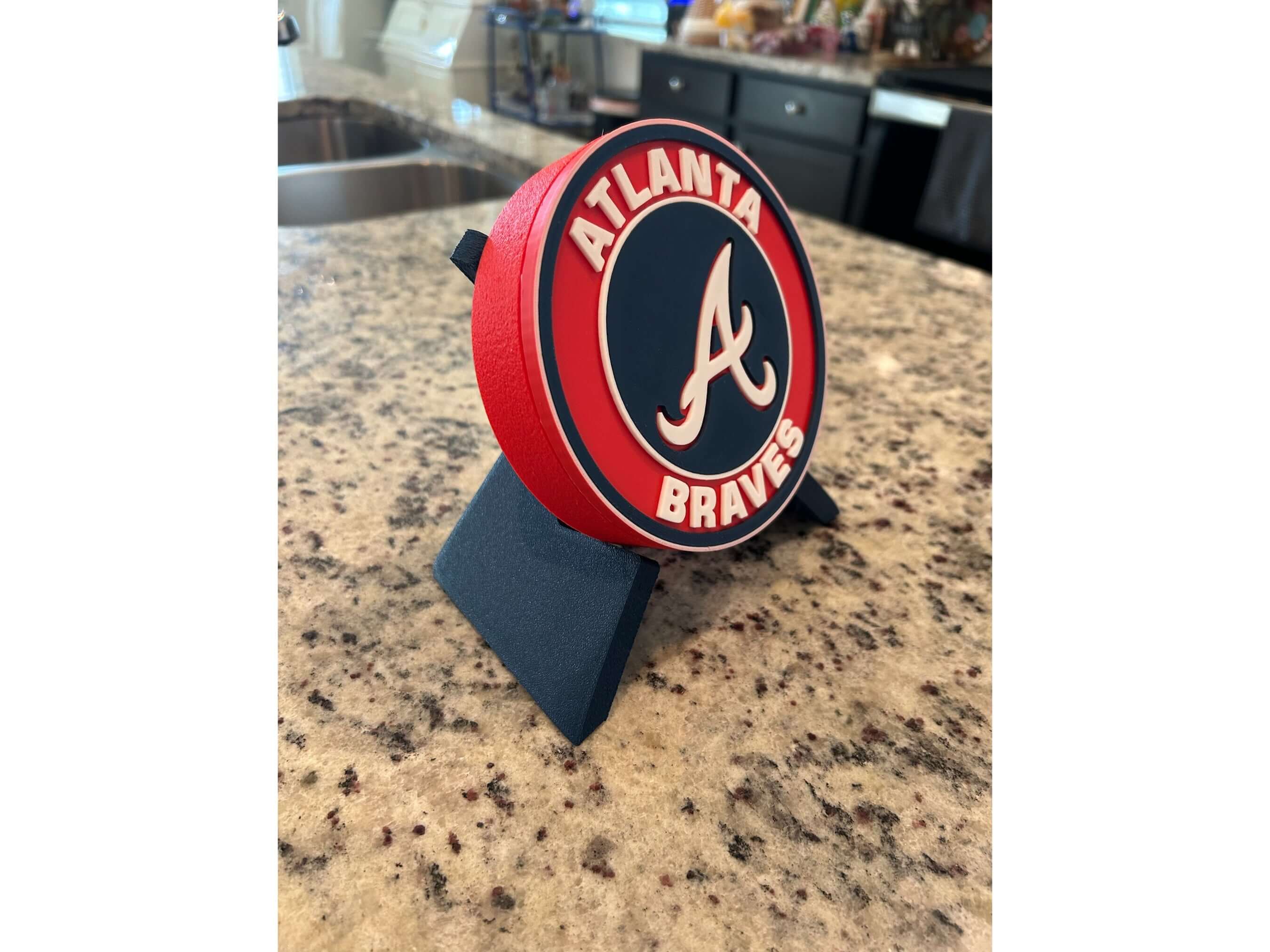 Atlanta Braves 3D printed plaque on a countertop, showcasing vibrant colors and high-quality materials, perfect for baseball fans.