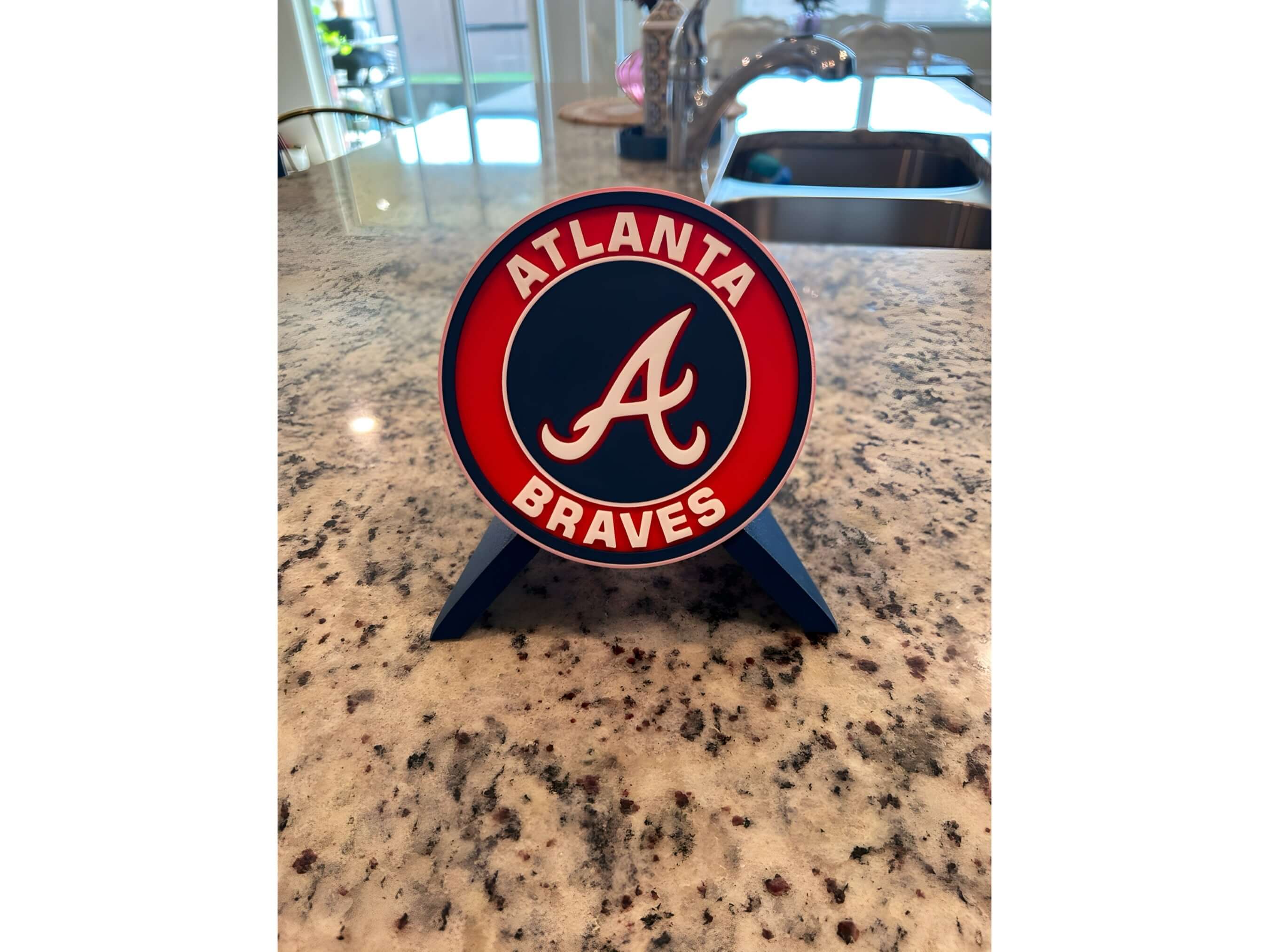 3D printed Atlanta Braves plaque on a countertop, showcasing vibrant colors and unique fan decor for baseball enthusiasts.
