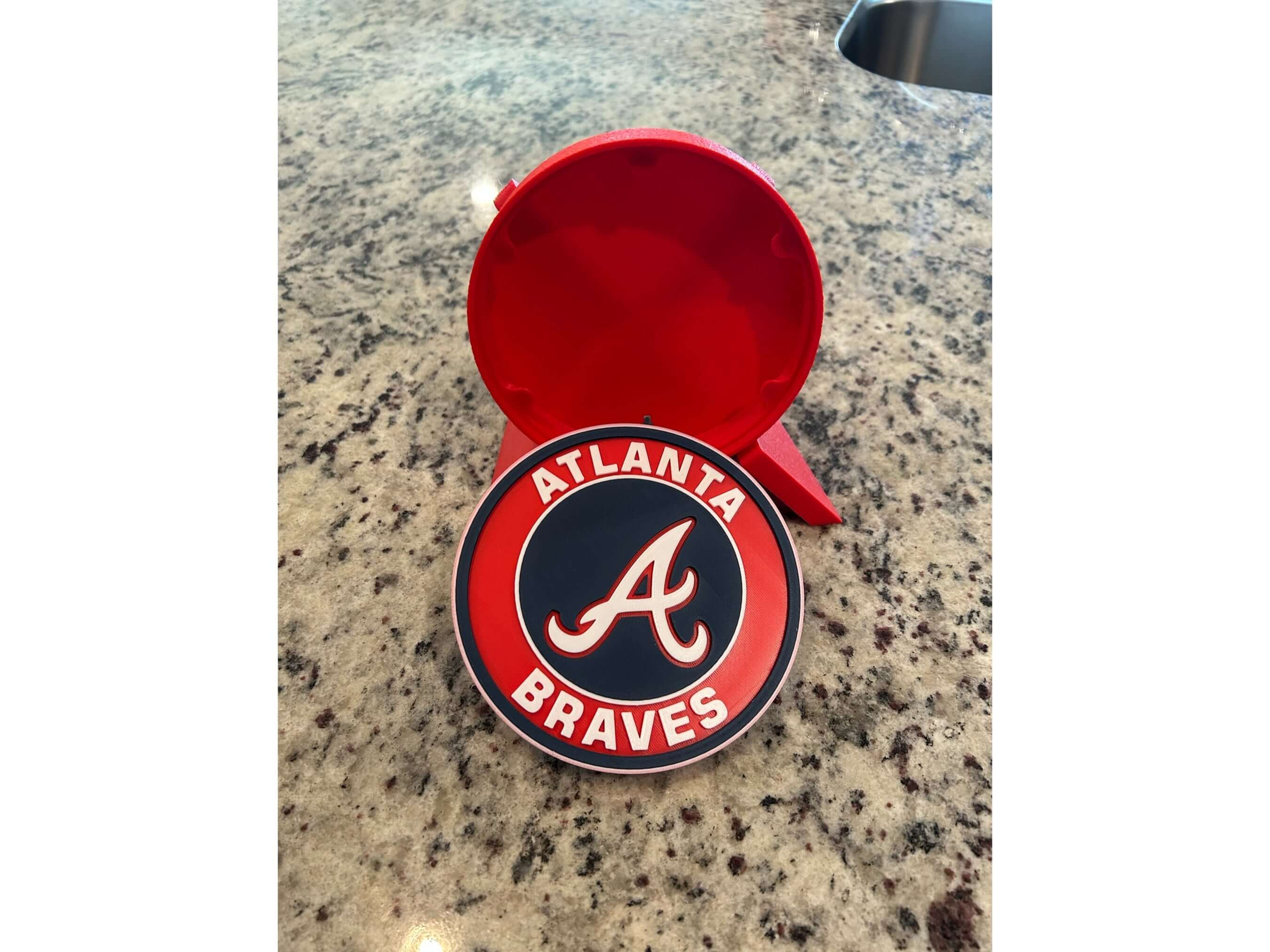 Atlanta Braves logo plaque in vibrant colors on a granite countertop, ideal for baseball decor and fan gifts.