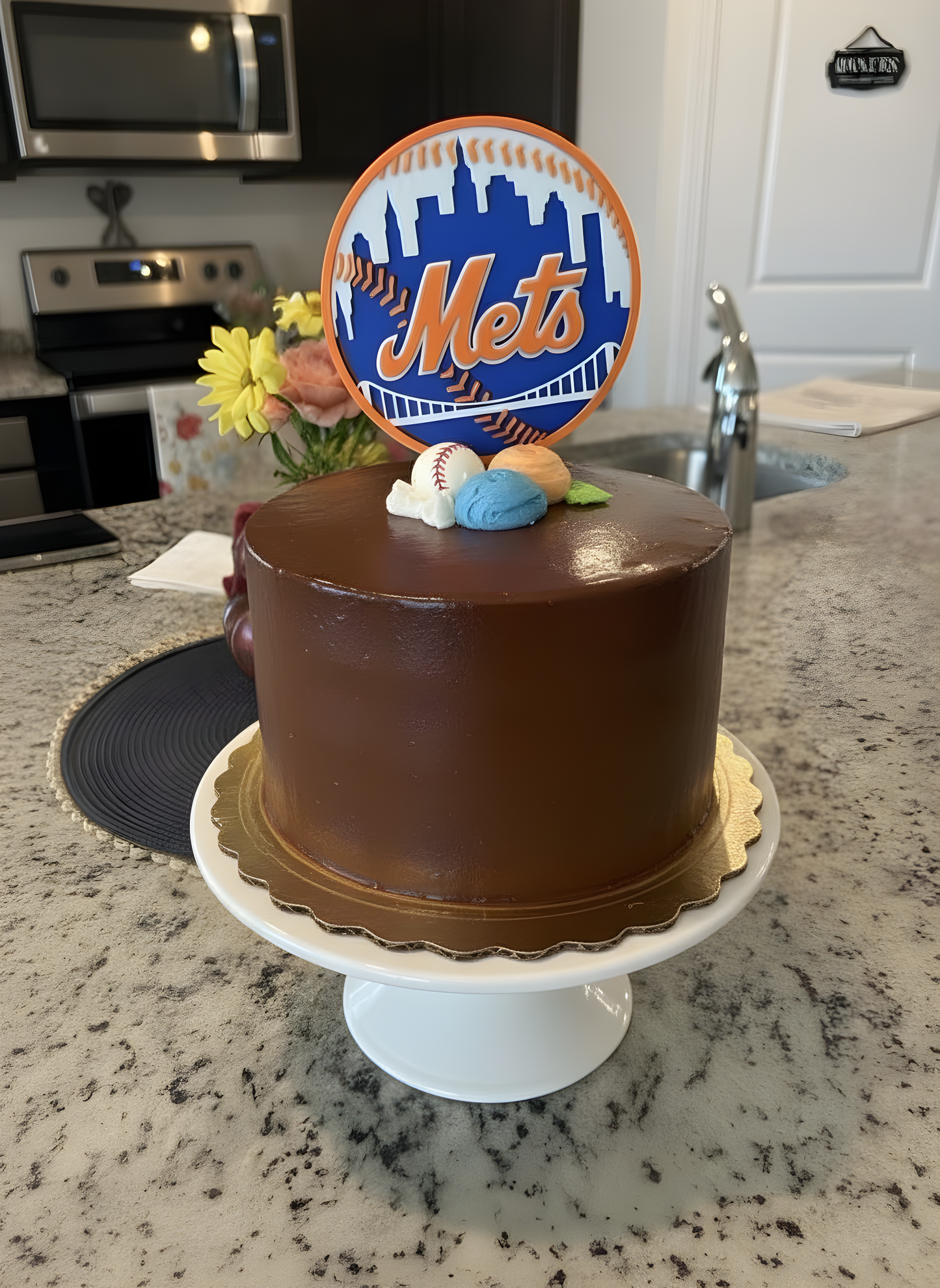 Mets cake topper on a chocolate-frosted birthday cake — proves it pops on dark frosting too