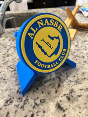 Al Nassr FC 3D printed plaque with blue and yellow logo, perfect for soccer fans supporting Ronaldo's team.