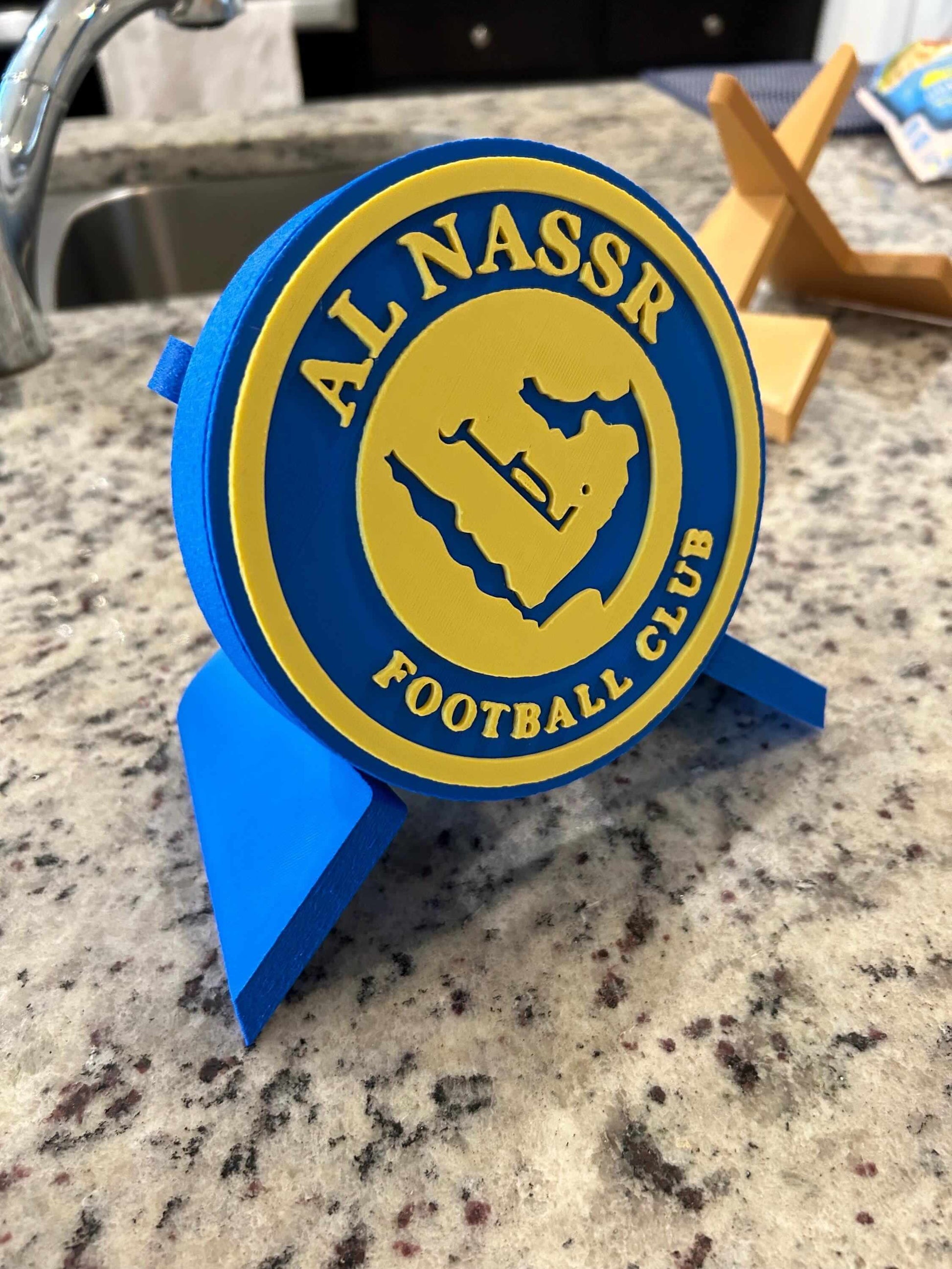 Al Nassr FC 3D printed plaque with blue and yellow logo, perfect for soccer fans supporting Ronaldo's team.