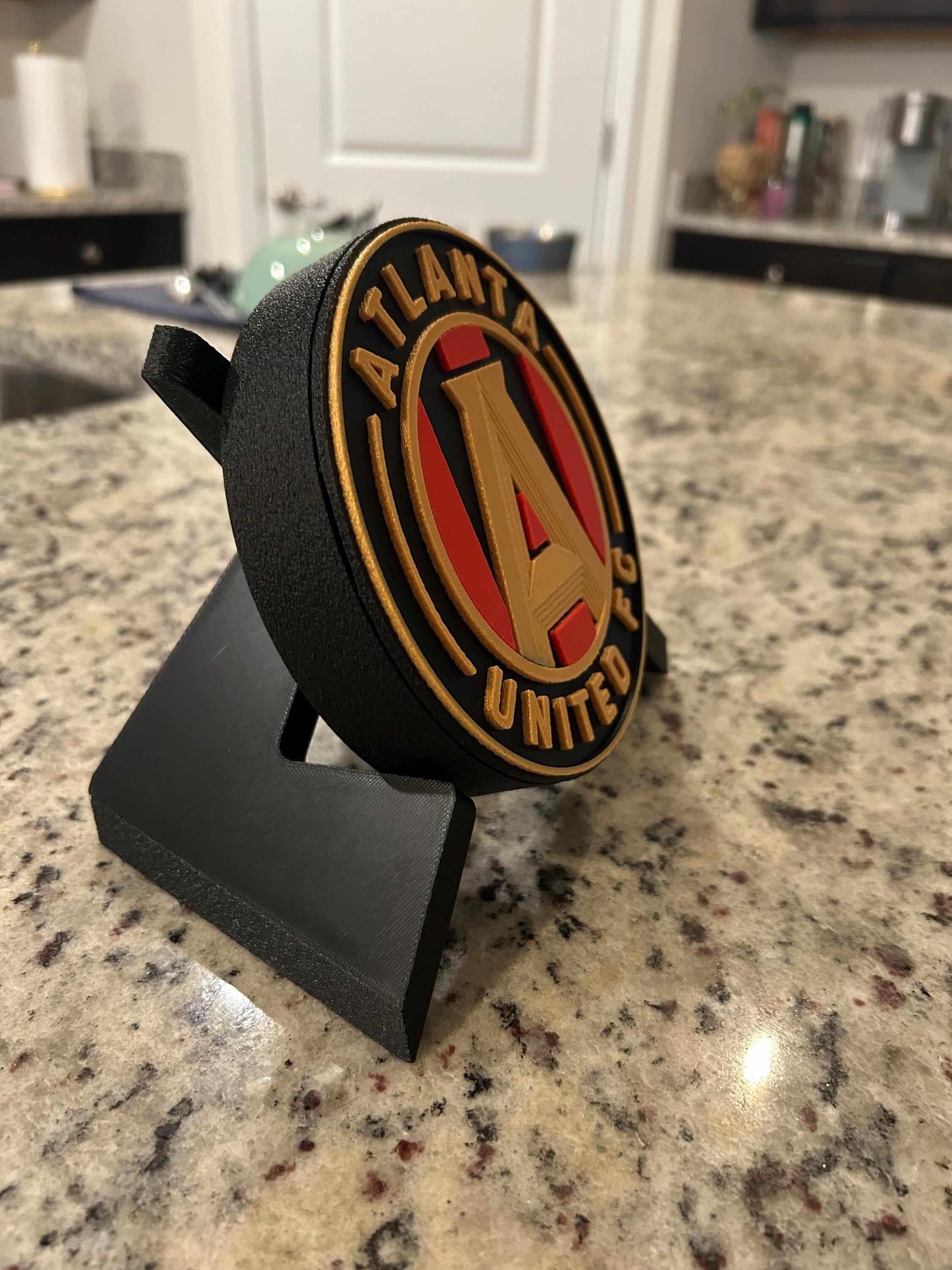 3D printed Atlanta United FC plaque on a stand, showcasing vibrant colors and custom design for soccer fans.