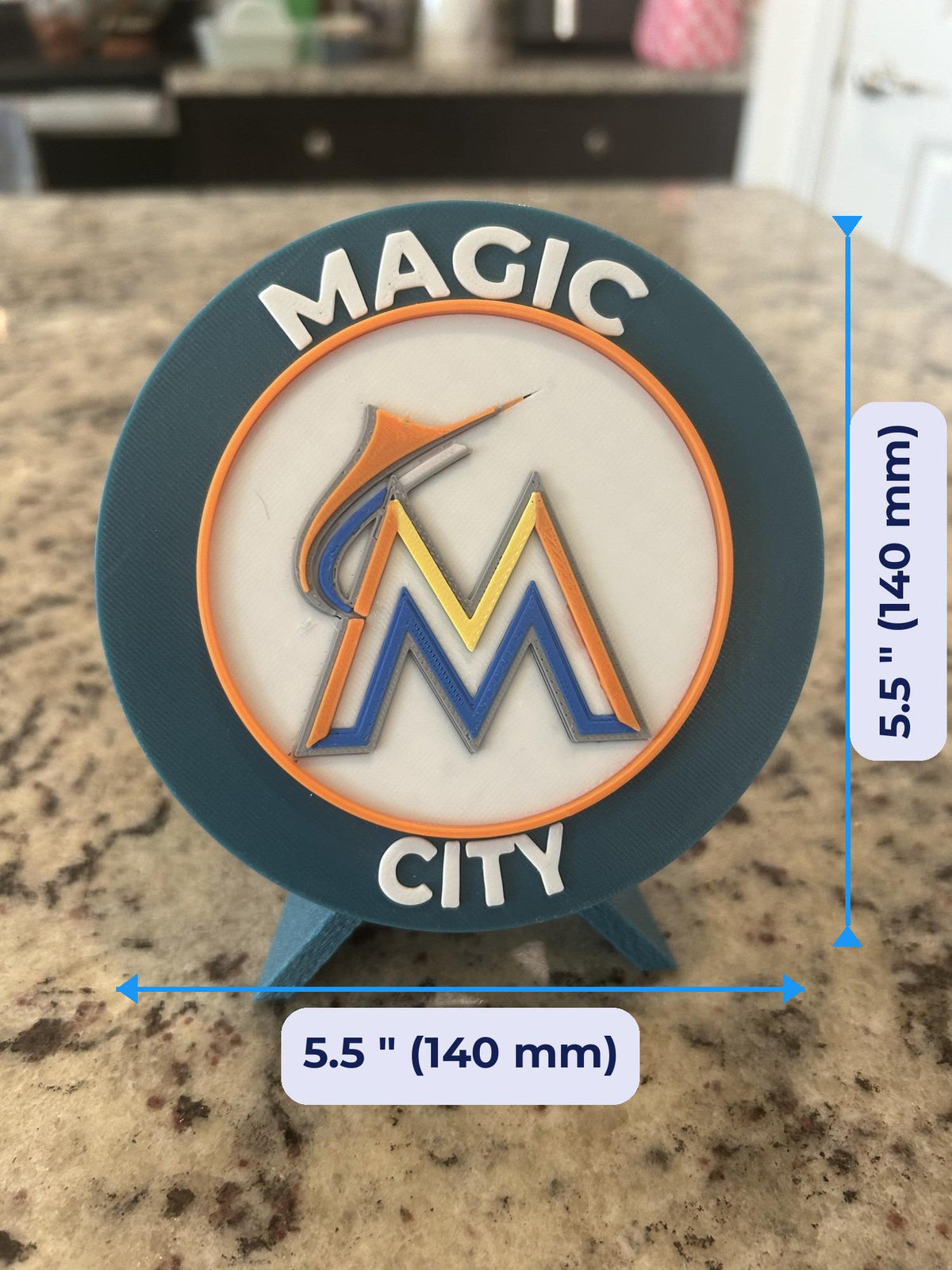 Size guide: Miami Marlins 3D printed round medallion 5.5 inches (140 mm) across, about 1 inch (25 mm) deep on the stand