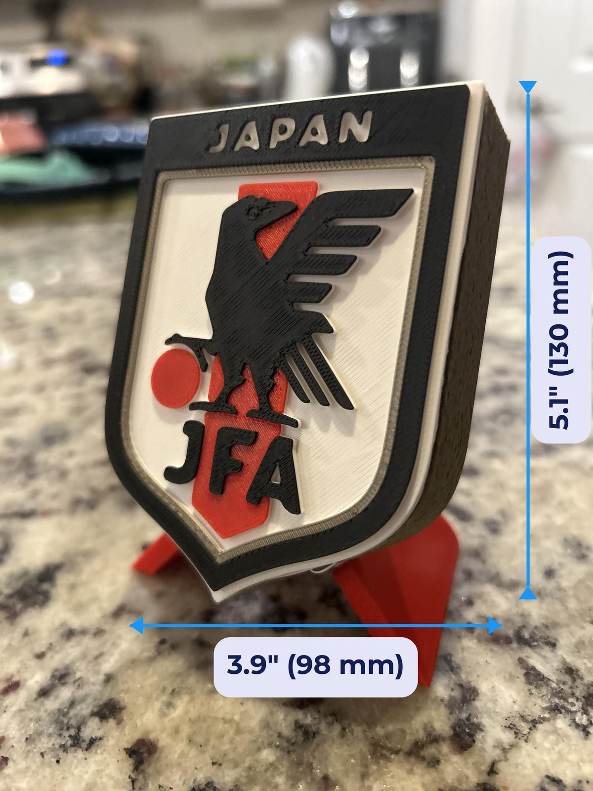 Japan JFA 3D printed shield crest display with red stand and hidden stash box, Samurai Blue soccer fan gift, made in USA
