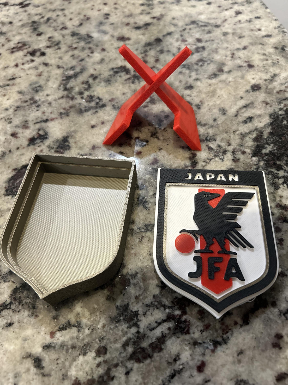 Japan JFA 3D printed shield crest display with red stand and hidden stash box, Samurai Blue soccer fan gift, made in USA