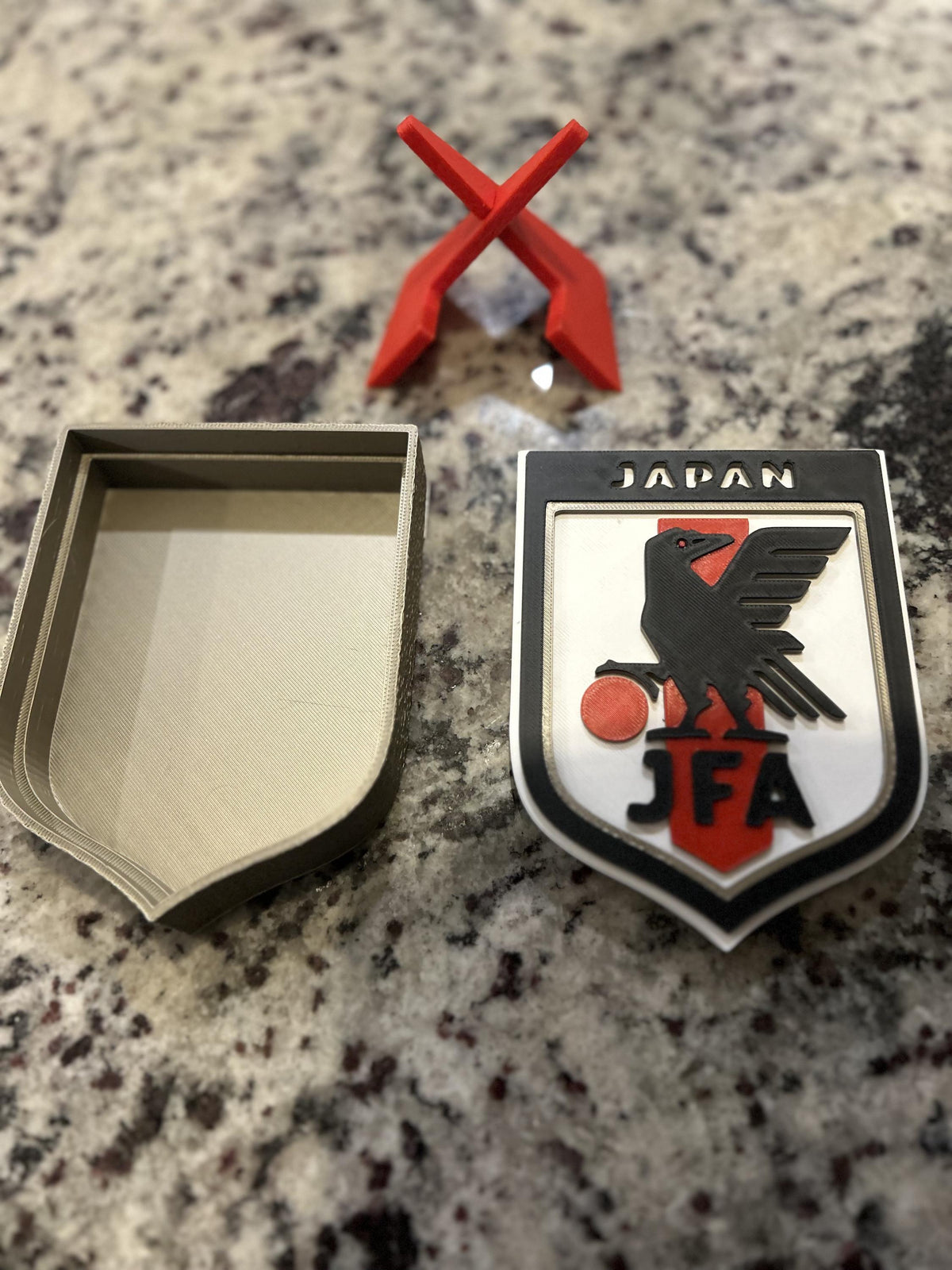 Japan JFA 3D printed shield crest display with red stand and hidden stash box, Samurai Blue soccer fan gift, made in USA