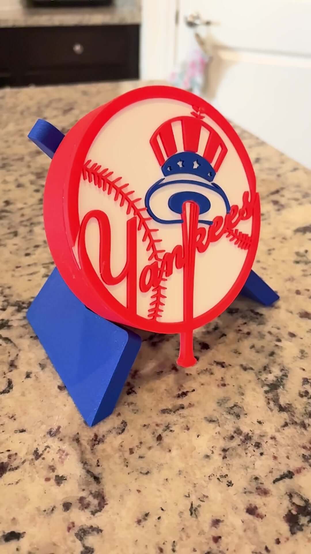 Load video: Customized New York Yankees 3D printed plaque on a countertop, showcasing vibrant colors and unique design.