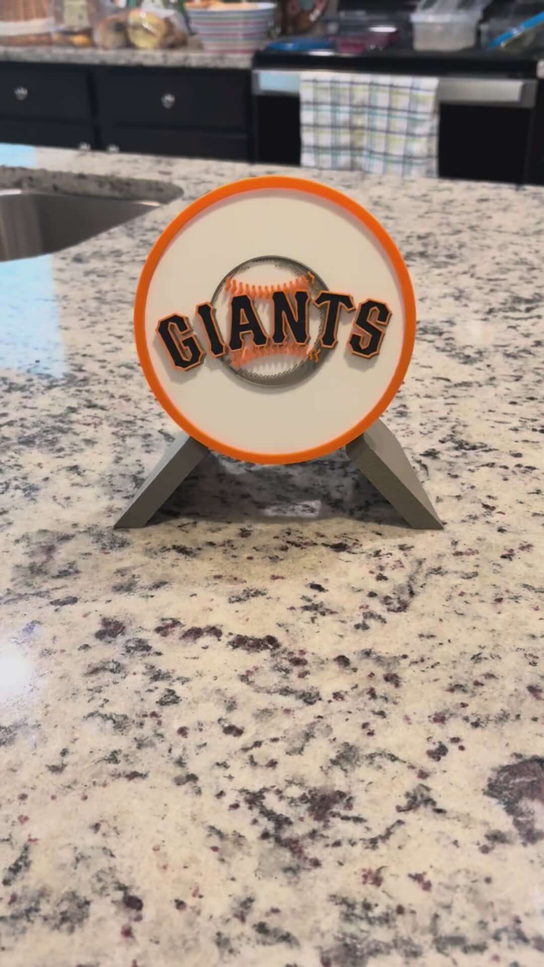 Load video: Customized San Francisco Giants 3D printed plaque on a kitchen counter, showcasing vibrant colors and unique design.