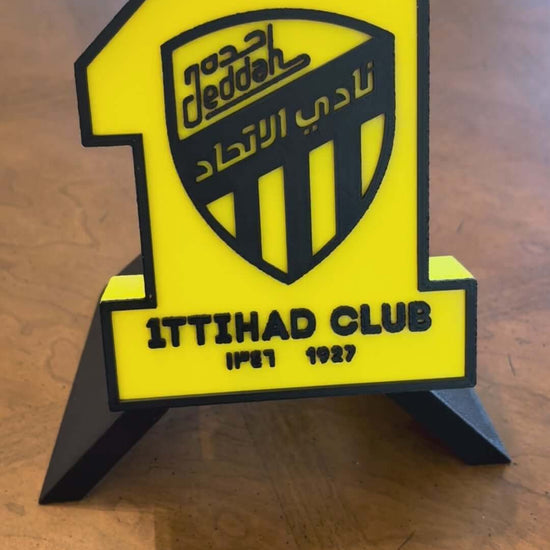 3D printed Al-Ittihad Club plaque, vibrant yellow and black decor, perfect for soccer fans, no assembly needed.