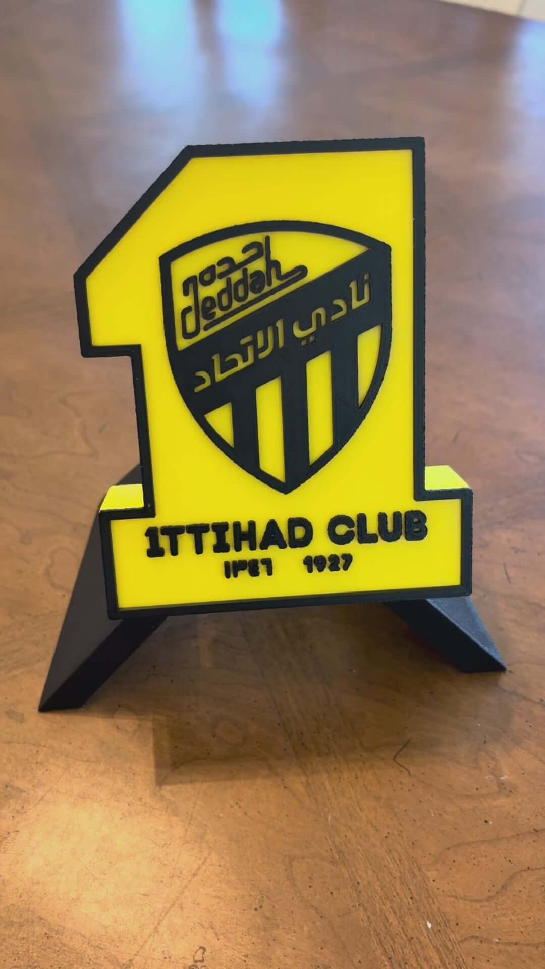 Load video: 3D printed Al-Ittihad Club plaque, vibrant yellow and black decor, perfect for soccer fans, no assembly needed.